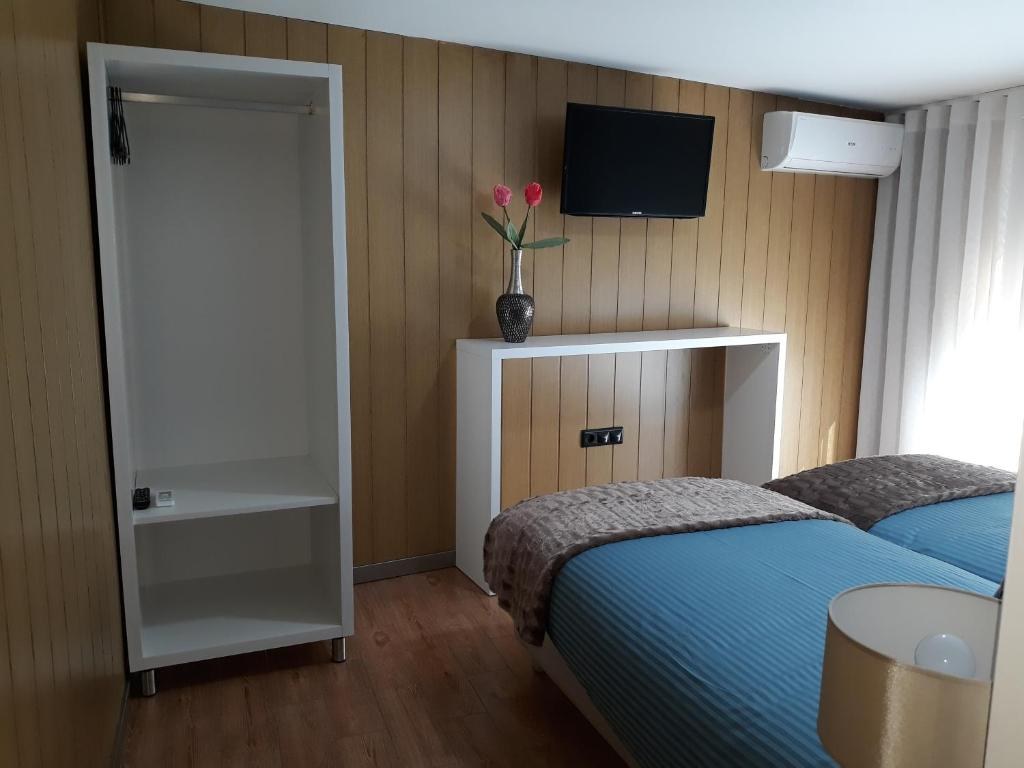 Guest room with television and air conditioning